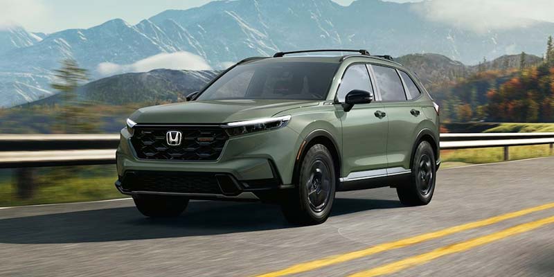 Green 2026 Honda CR-V Hybrid on a mountain road 