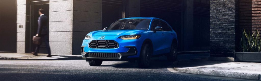 2026 Honda HR-V parked on city street with a businessman walking by